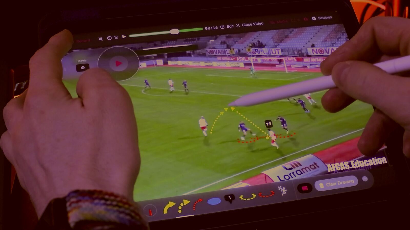 The Football Toolkit: arrows, a numbered player label and dotted runs drawn over match footage